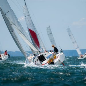 a group of people riding on the back of a boat in the water