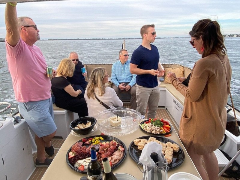 a group of people sitting at a table with food