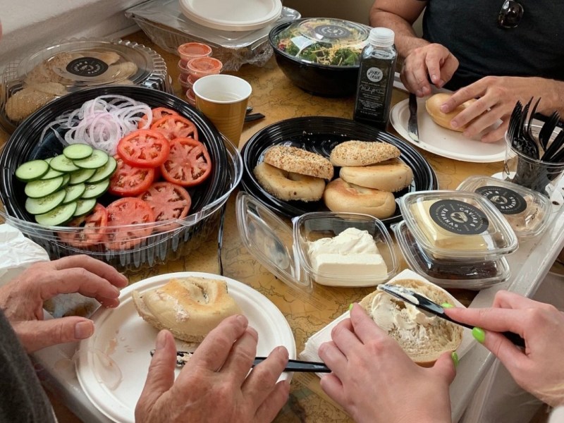 a group of people sitting at a table with a plate of food