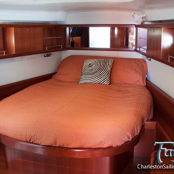 a bedroom with a bed and a chair in a room