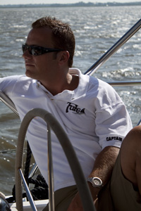 a person sitting next to a body of water