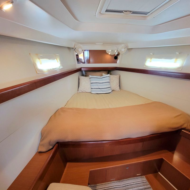 a bedroom with a bed and desk in a room