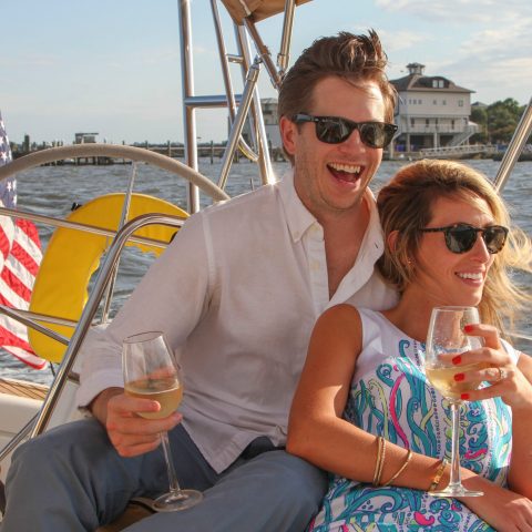 a man and a woman sitting on a boat in the water