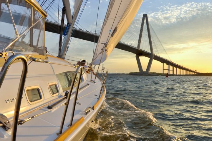 a close up of a boat next to the Arthur Ravenel Jr. Bridge