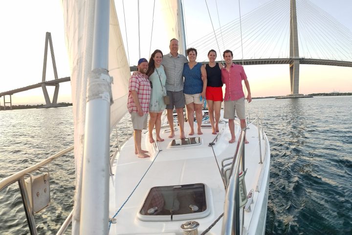 a group of people standing next to a body of water