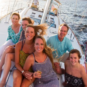 a group of people on a boat posing for the camera