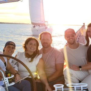 a group of people posing for a photo at sunset