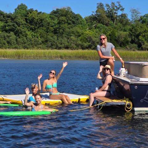 a group of people rowing a boat in the water
