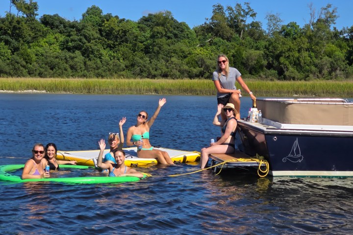 a group of people rowing a boat in the water