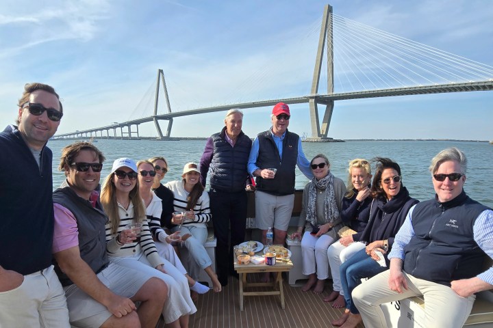 Jonathan Freeman et al. on a bridge over a body of water