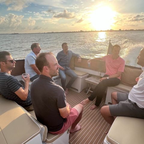 a group of people sitting at a beach