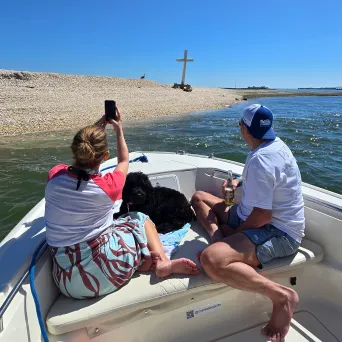 a group of people sitting in a boat on a body of water
