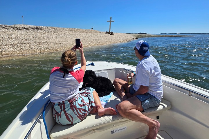 a group of people sitting in a boat on a body of water