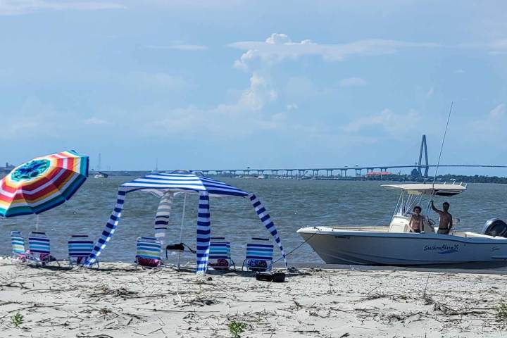 a boat sitting on top of a sandy beach