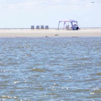 a man standing next to a body of water