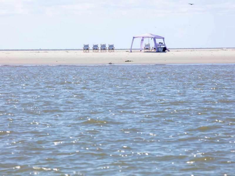 a man standing next to a body of water