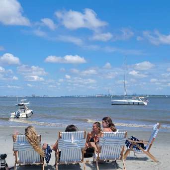 a group of people on a beach near a body of water