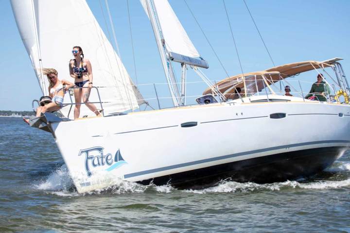 a man riding on the back of a boat in the water