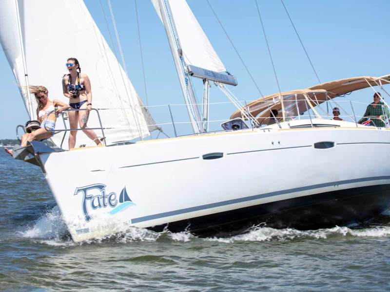 a man riding on the back of a boat in the water