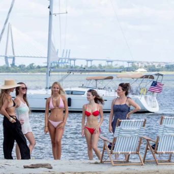a group of people standing next to a body of water